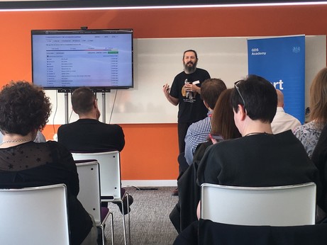 Terence talking in front of a screen that shows a Github repo