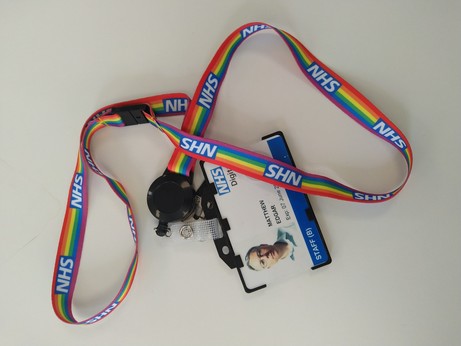 Lanyard with rainbow stripes and NHS logos, holding my NHS Digital staff pass