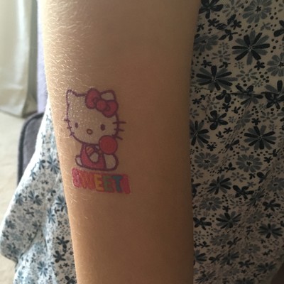 A child’s Hello Kitty temporary tattoo with the word “sweet” on it