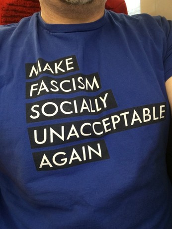 A blue T-shirt with the slogan “make fascism socially unacceptable again”