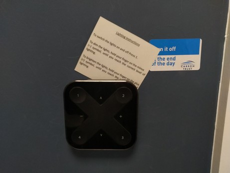 Sign above complicated light switch says "To switch the lights on and off Press 1."