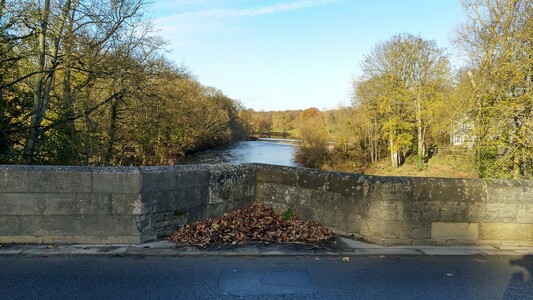 View of river from middle of a stone bridge
