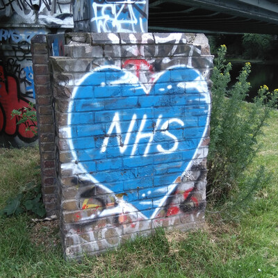 graffiti: the letters NHS on a blue heart