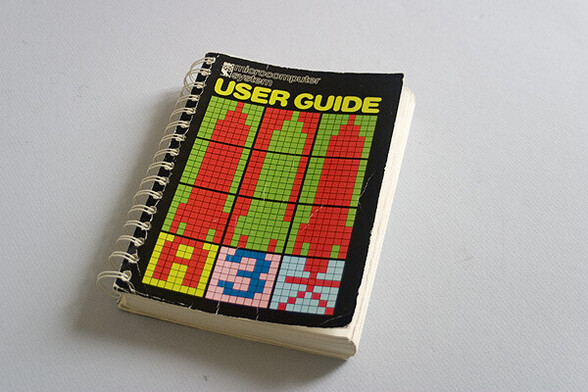 BBC Micro User Guide - A ring-bound book with pixelated graphics on the cover