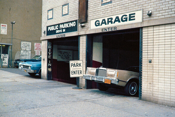 New York 1979: Aero Garage, 147-149 East 24th Street. 1978 Ford Thunderbird exits underground car park. Blue 1970 Ford Galaxie in the alley. 