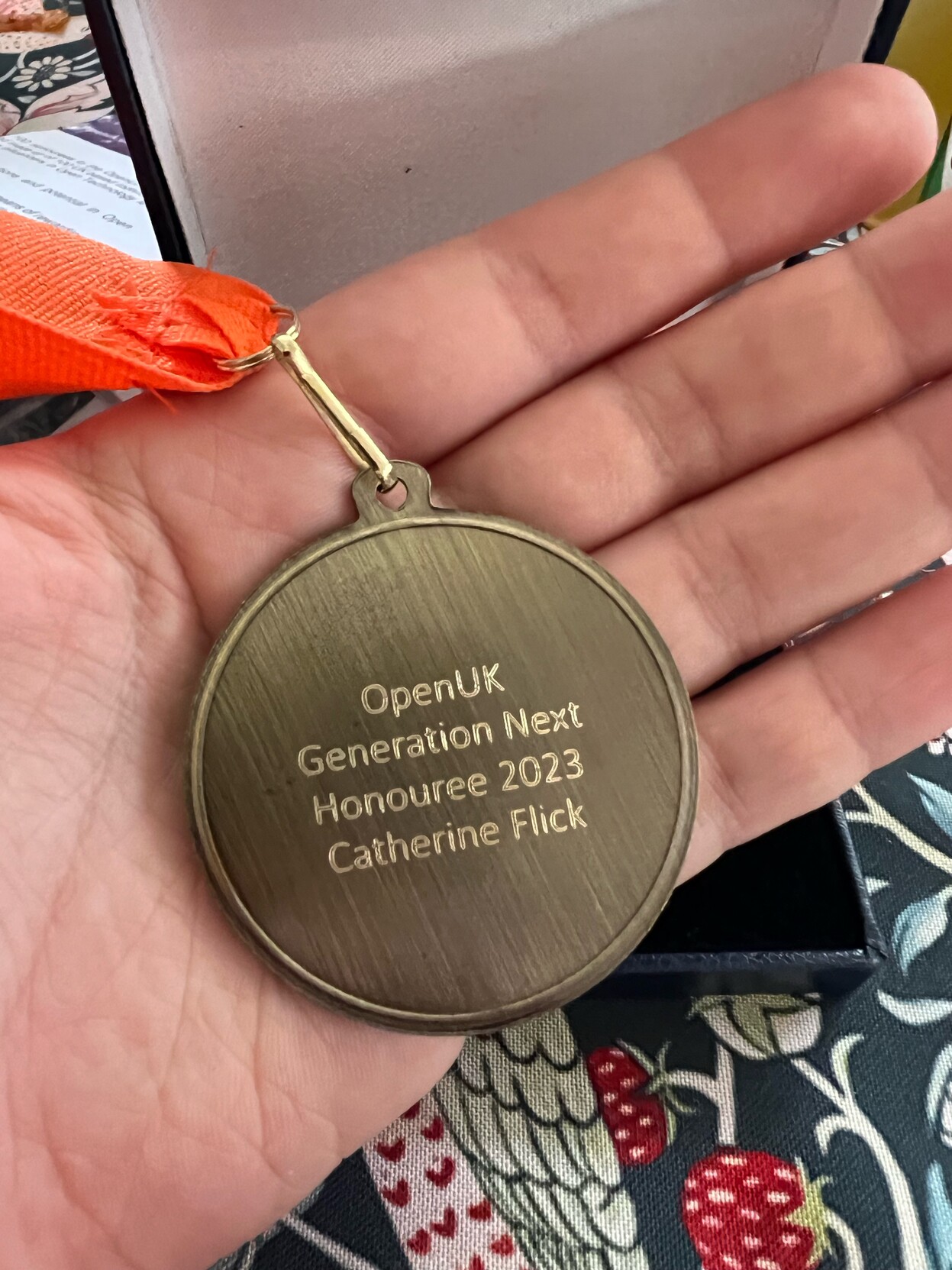 An image of a medal engraved with: OpenUK Generation Next Honouree 2023 Catherine Flick