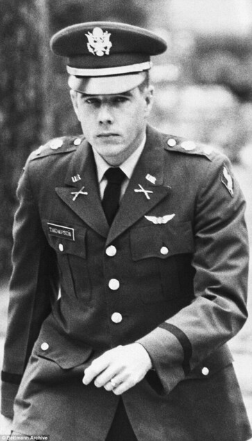 Thompson walking determinedly, in full uniform, at the enquiry