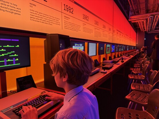 My son playing on an retro computer.