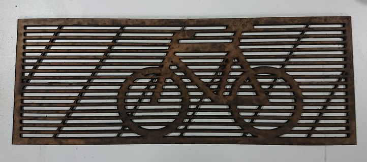 A laser-cut grille with a bike silhouette overlaid in the design 