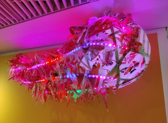 A "comet" consisting o af spherical framework of plastic strips and other strips attached as tails, covered with ironed soft plastic panels and "flames". The spherical part is lit from the inside and the tails have coloured LEDs along their length