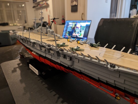 Close up of brick built carrier showing planes on deck and guns
