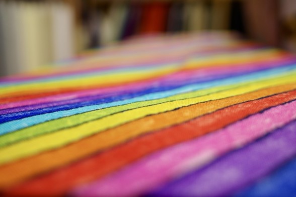 A brightly coloured striped pattern on some fabric, like a neon rainbow