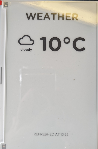 A e-ink display showing the current weather conditions.