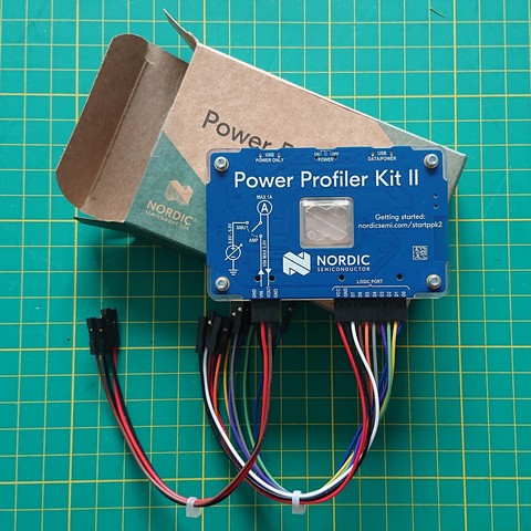 A blue circuit board with some wires attached.  The text on the board reads "Power Profiler Kit II" from Nordic Semiconductors