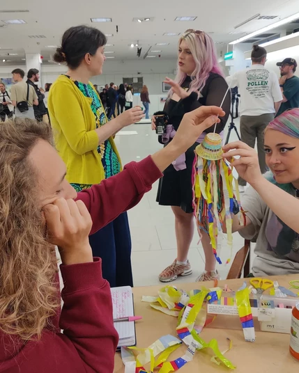 Visitors making a small Kelly to add to the display