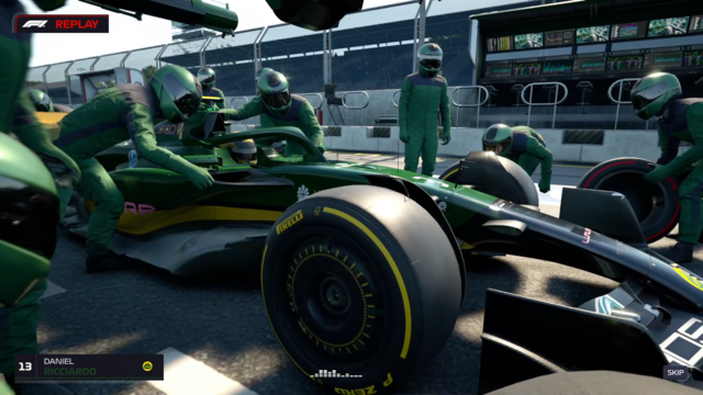 green racing car in pit stop (screenshot)
