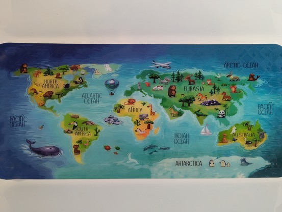 Bath mat with an awful world map missing lots of islands, including the countries of the UK, Ireland, Japan, Cyprus, and all those in the Carribbean