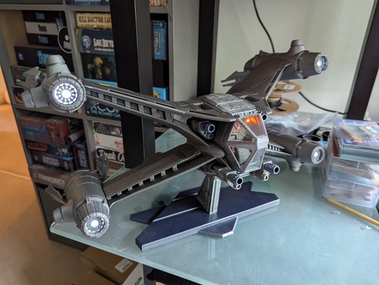 3d printed spaceship (with lights) assembled on a stand - a Starfury small 1 person fightercraft from Babylon 5