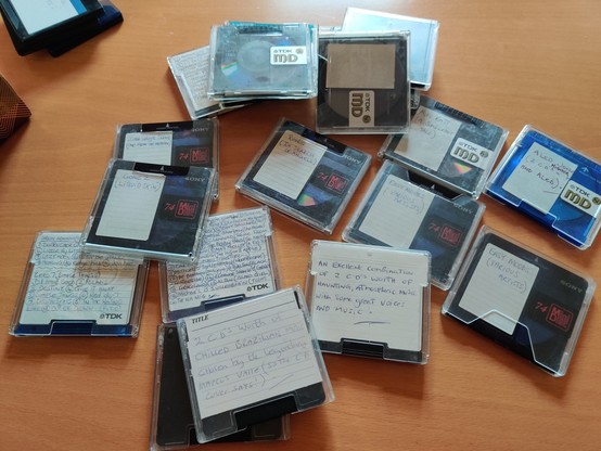 a pile of minidiscs strewn randomly on a desk