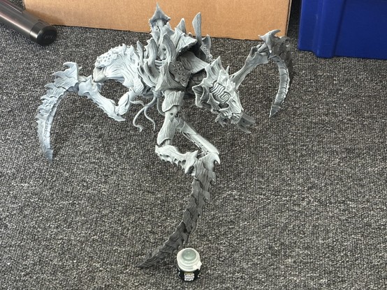 A very large "miniature", 30x30x30cm, of a huge alien creature that resembles a cross between an armour plated spider and a Xenomorph from Alien.