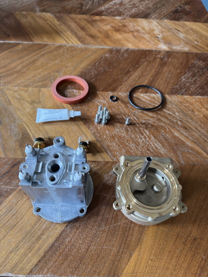 The disassembled boiler and associated parts of a Gaggia Classic coffee machine, ready for assembly and fitting. 