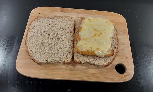 Fish finger and cheese sandwich, shown open so you can see what is in it.