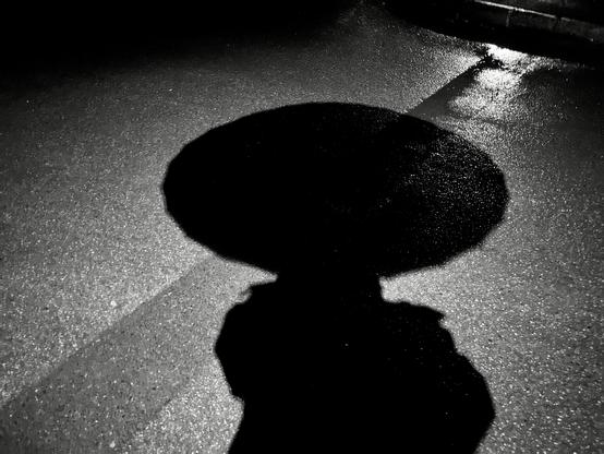 B/w image of my shadow cast on the ground - it looks like I have an enormous head because I’m holding an umbrella 