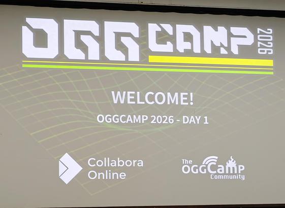 Slide from the opening session of #OggCamp2026 saying "Welcome to OggCamp Day 1"